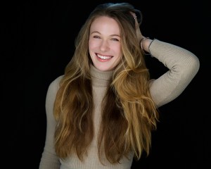 Woman smiling with a black background