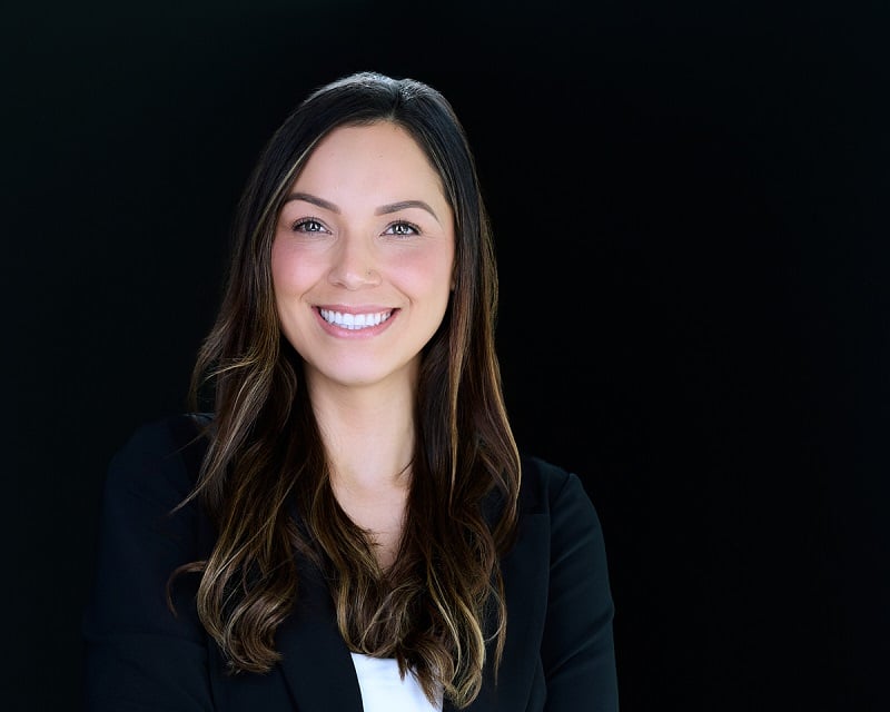 Woman smiling with a black background